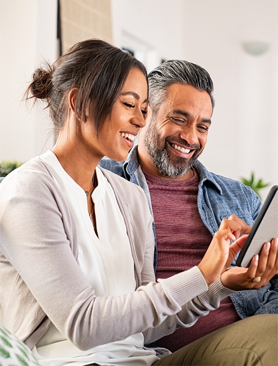 Woman and man holding a tablet